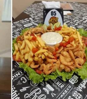 Porção de fritas com filé de frango e molho da casa sobre a toalha estampada da Elza